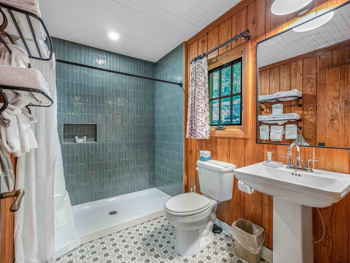 Devil's Den State Park cabin bathroom, tile shower and pine paneling, built by Covenant Commercial Construction
